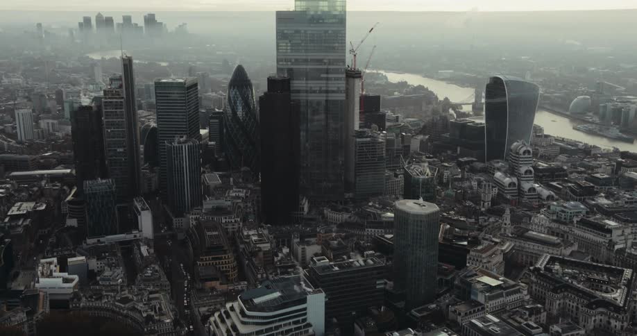 The tall buildings fill the foggy city sky