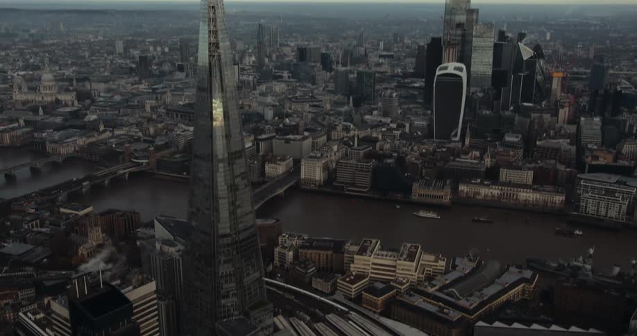 Aerial view of high rise buildings with tower and bridges over river in the city