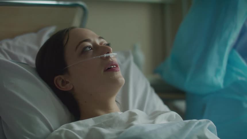 Woman recieving treatment in hospital bed