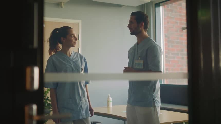 Nurse coworkers communicating in a hospital room