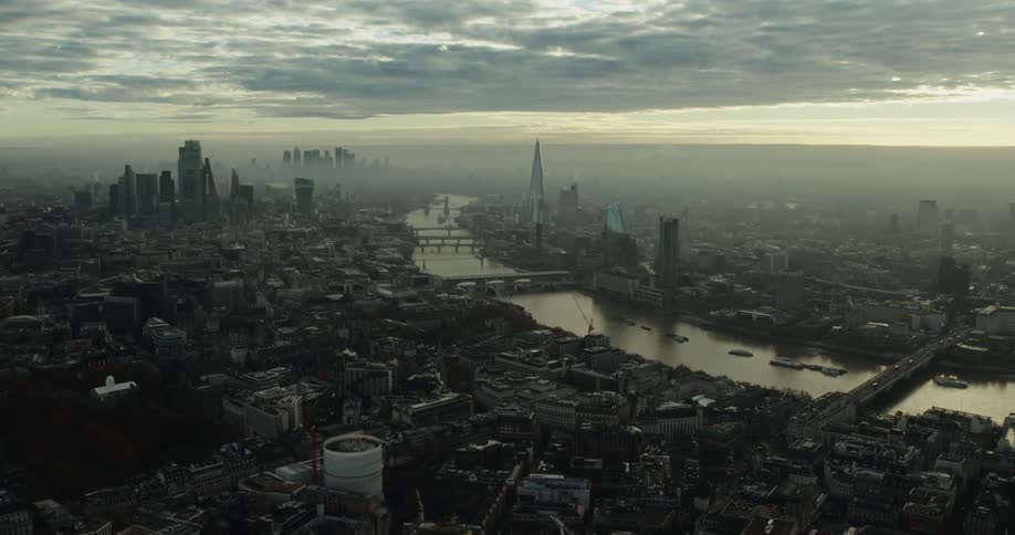 A river through a metropolis on a foggy evening