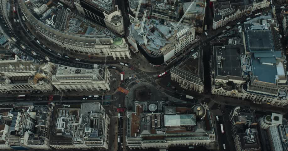 Aerial view of city buildings and highways with vehicles in the city