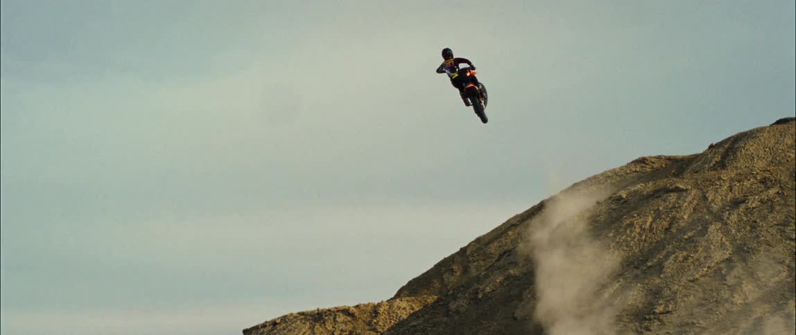 A person jumping a dirt bike outdoors