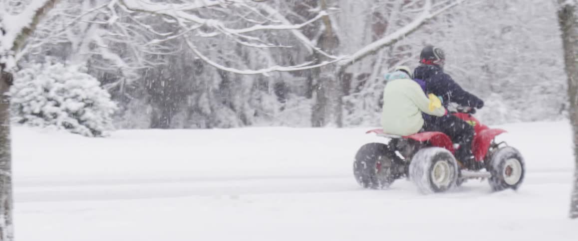 People on an atv in the snow