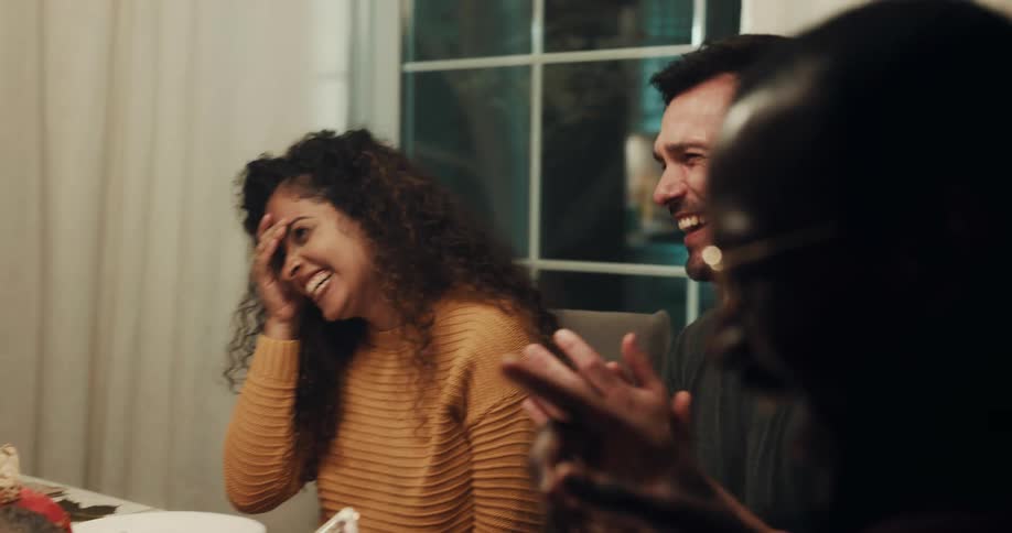 Friends laughing having a goodtime gathered at the dinner table
