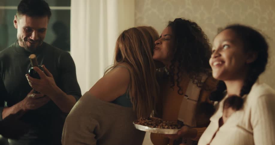 Family and friends greet each other as they arrive at house for dinner