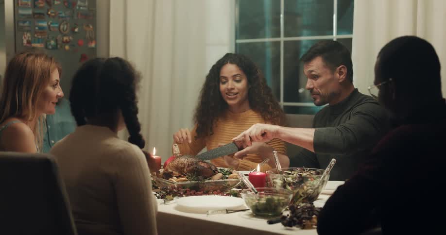 Friends finish saying grace then determine who will carve the meat