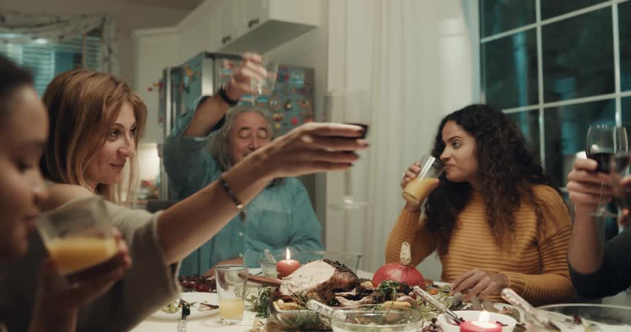 A group of friends eating and drinking in a house