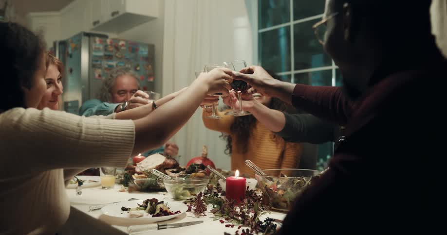 A group of friends eating and drinking at a table