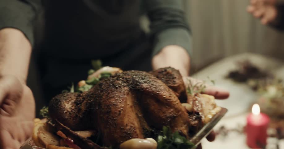 A turkey being served on a dinner table for thanksgiving