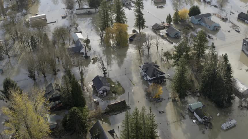Murky floodwaters surround homes in a storm damaged neighborhood