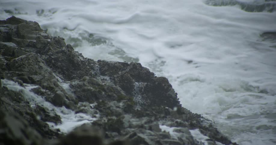 Ocean waves crashing against rocky coastline