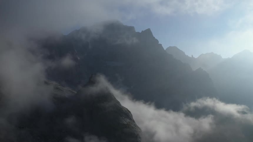 Mountain tops are obscured by dense clouds