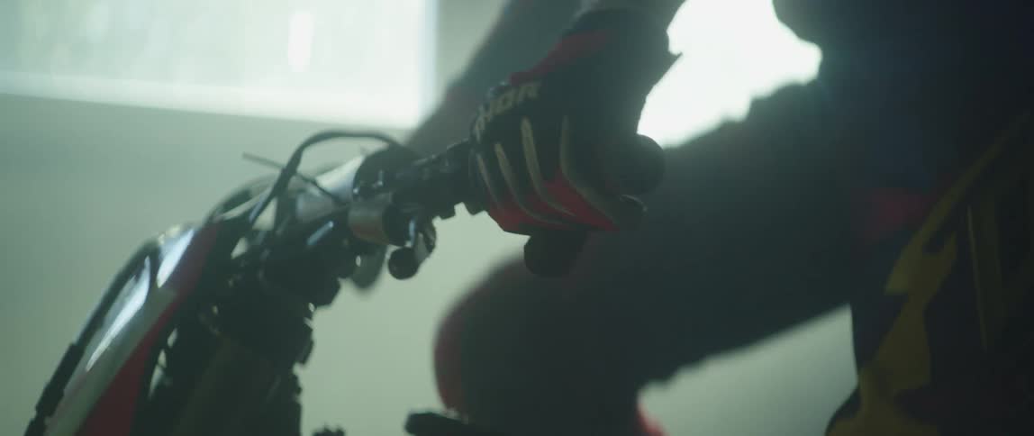 A person is starting their dirt bike