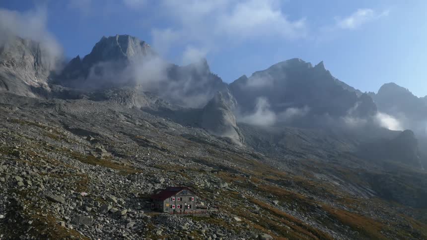 A house sits on the side of a steep mountain