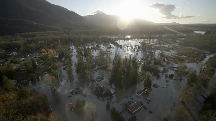 A mountain town is completely flooded at sunrise