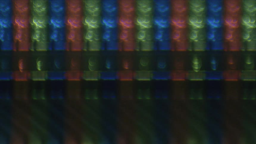 Out of focus blurry close up of rows of led yellow red and blue lights moving up rapidly