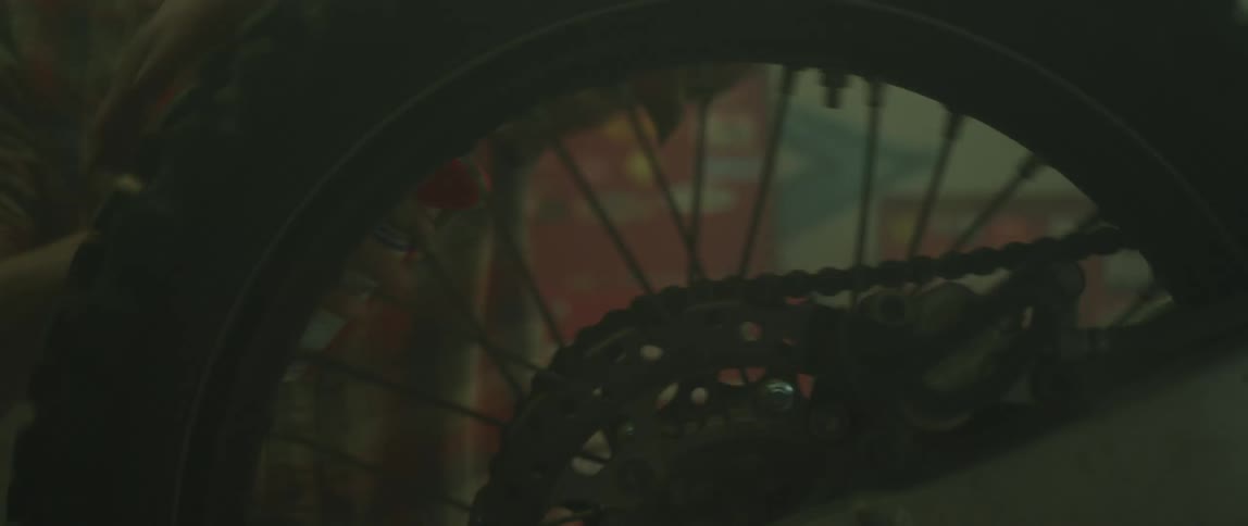 Person spinning the wheel of a dirt bike