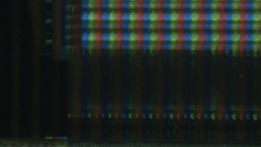 The microscopic image is of multi colored lines