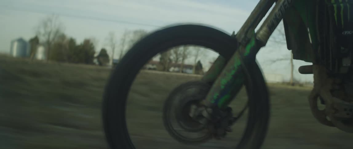 A dirt bike is racing across the field