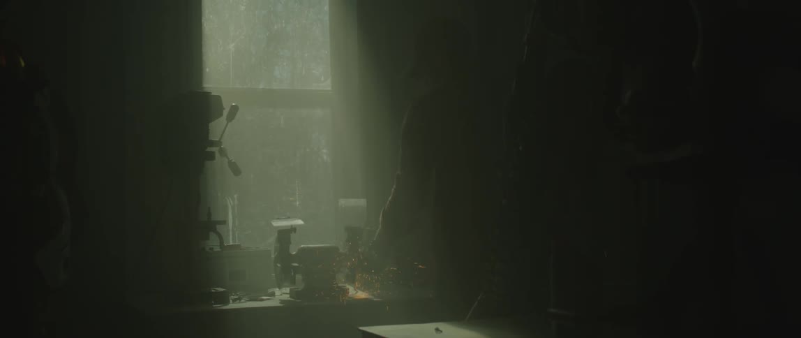 A man stands by the machine in the dark room