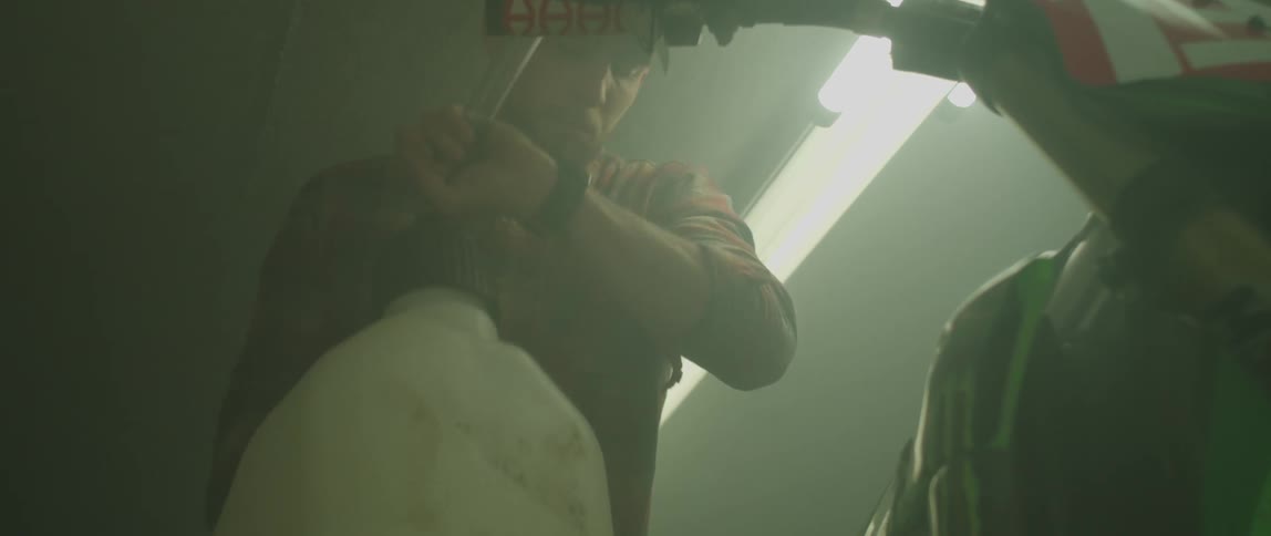 A man pours gas in to a motorcycle tank