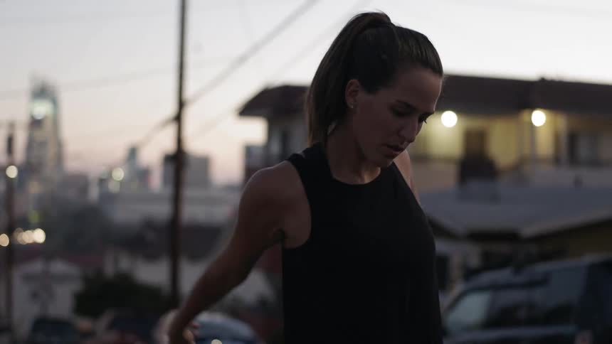 A woman stretches outdoors