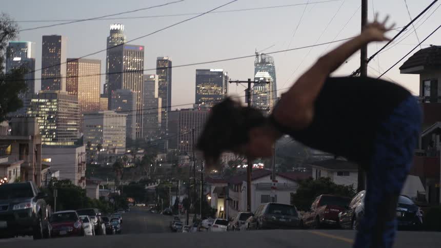 A woman is stretching in the street