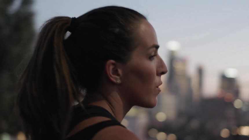 A woman views the city before turning around