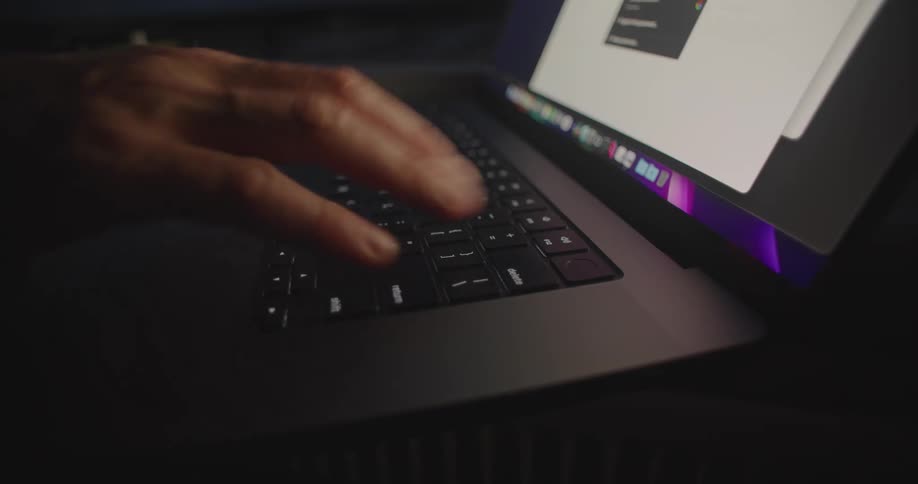 A person is typing on their laptop