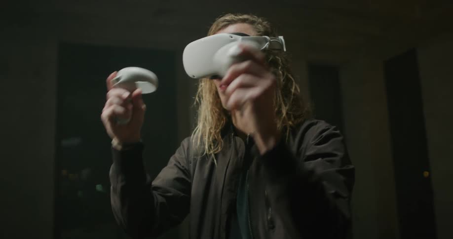 A man holding controllers moving his arms playing a virtual reality game