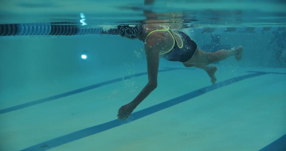 An elderly woman swimming in a pool