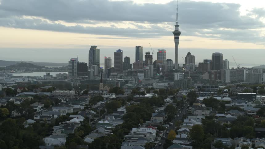 A sprawling neighborhood lays next to a large city area that is on the waterfront