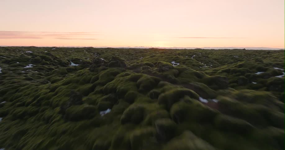 Ice dots rough terrain stretching to red sky