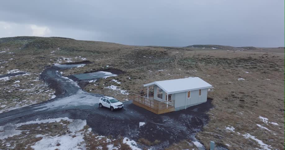 Aerial of a man walking into a house in the middle of no where