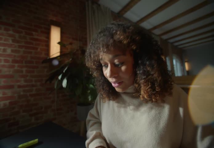 A woman looks surprised as she types on the keyboard