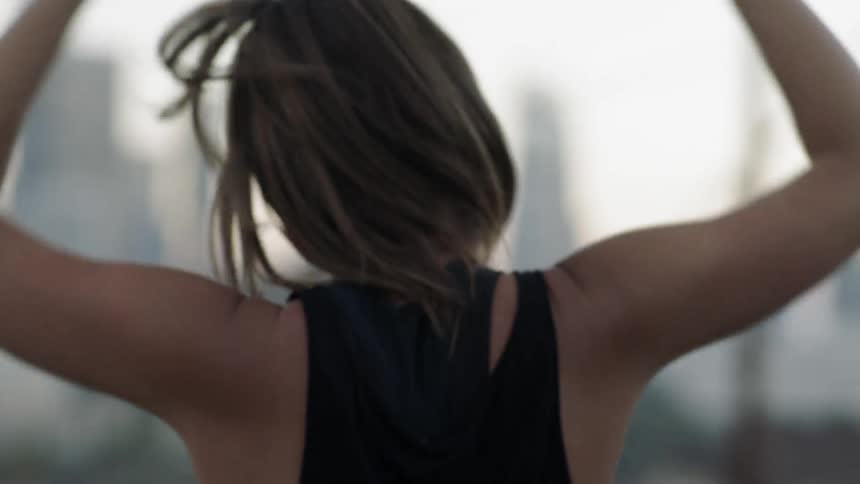A woman is jumping in place before stretching