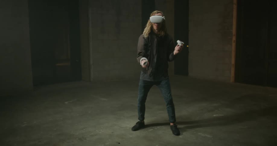 A man moves his arms up and down while playing a virtual reality game