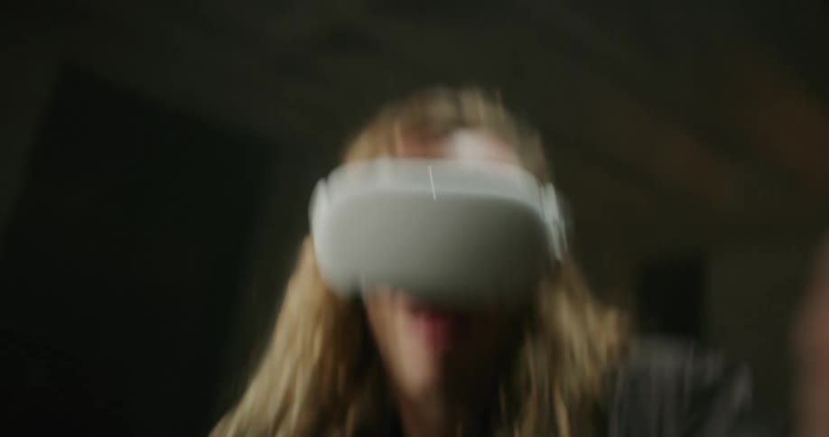 Blonde man plays game while wearing a vr headset