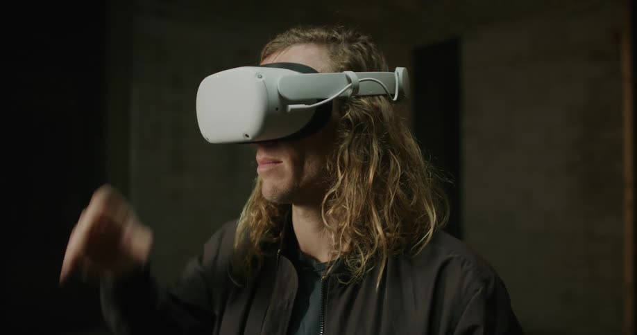 A man pulls a virtual reality headset over his eyes