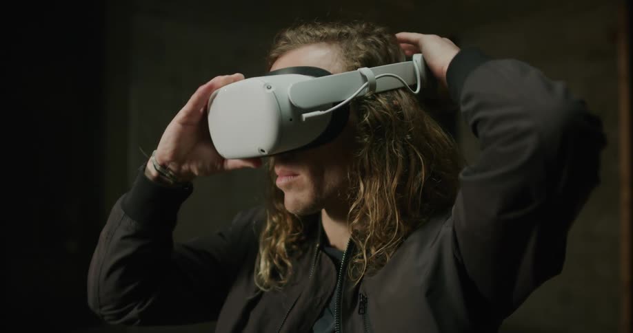 A man puts on a virtual reality headset