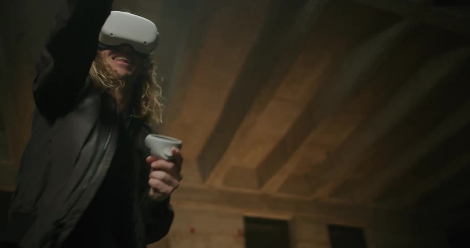 A man is moving his hands around as he plays a virtual reality game