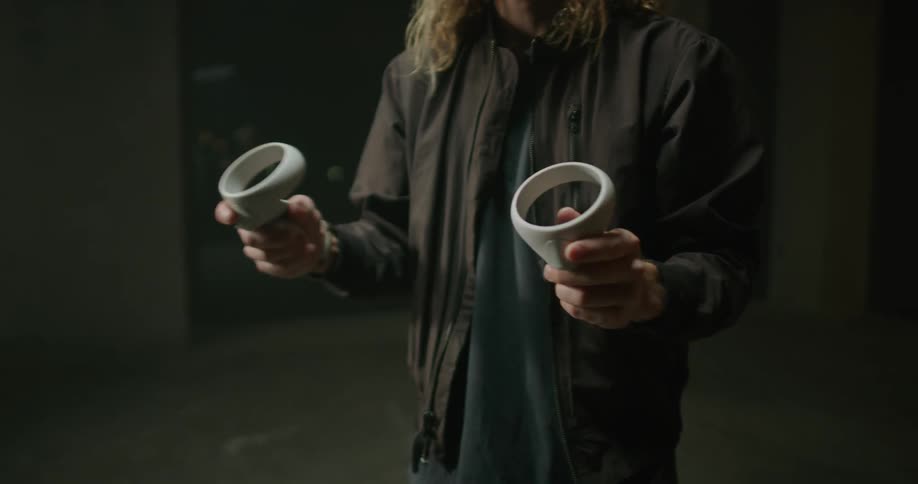 A man is waving game controllers around