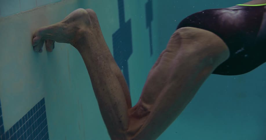 A person is swimming underwater in the pool