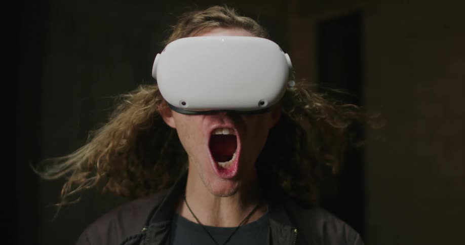 A man exclaims in wonder while wearing a virtual reality headset
