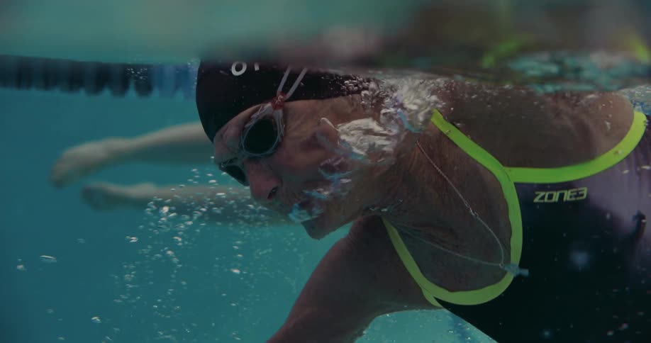 A woman is swimming in the pool
