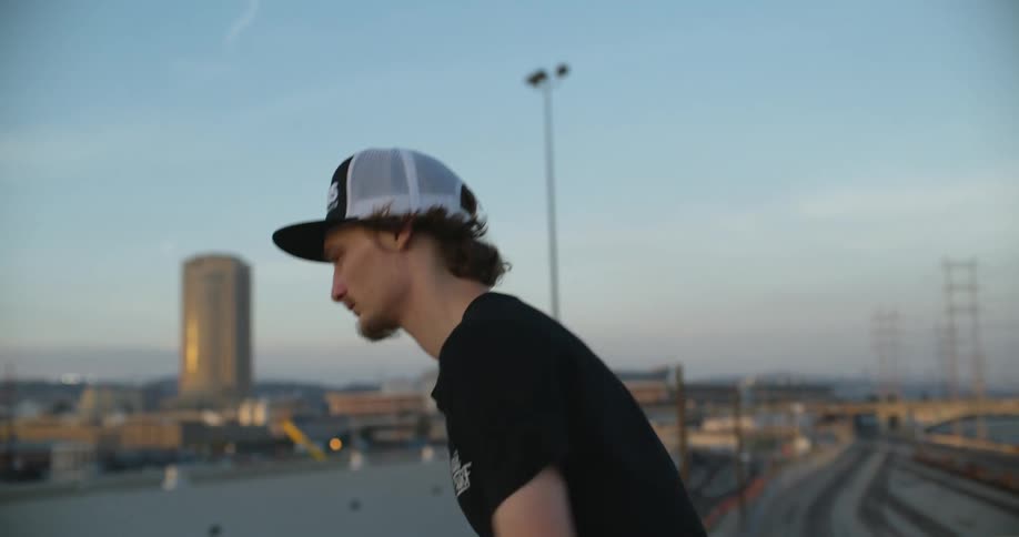 A man is skateboarding on the overpass