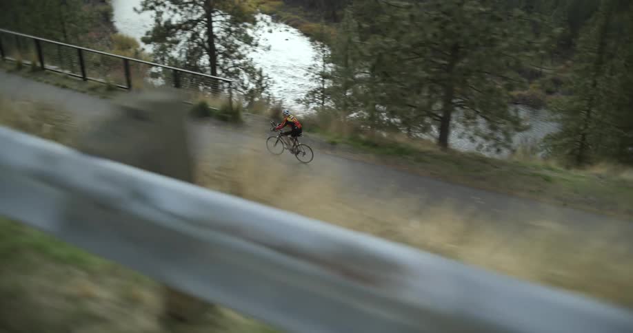 A person is riding a bike on a sidewalk in spring