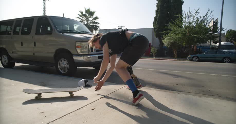 A man jumps off the stairs on the skateboard crashing