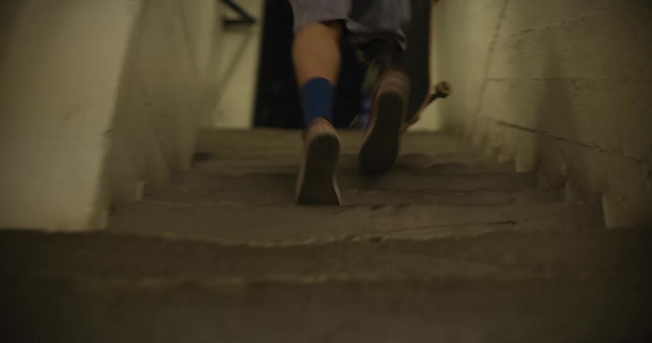 A man with a prosthetic leg is running up a set of stairs
